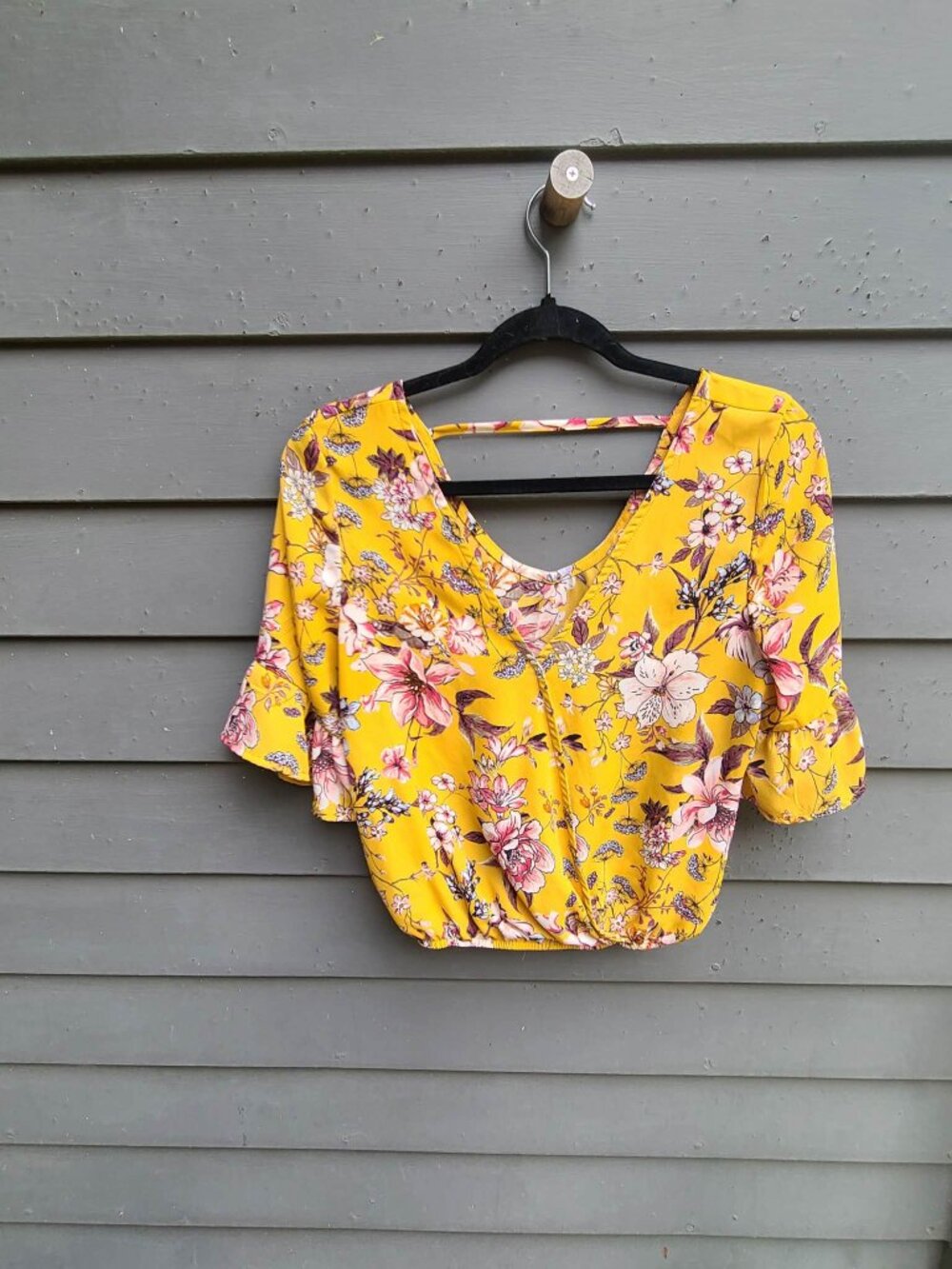 Live to Be Spoiled Gold flower Top with Cut out Back Medium